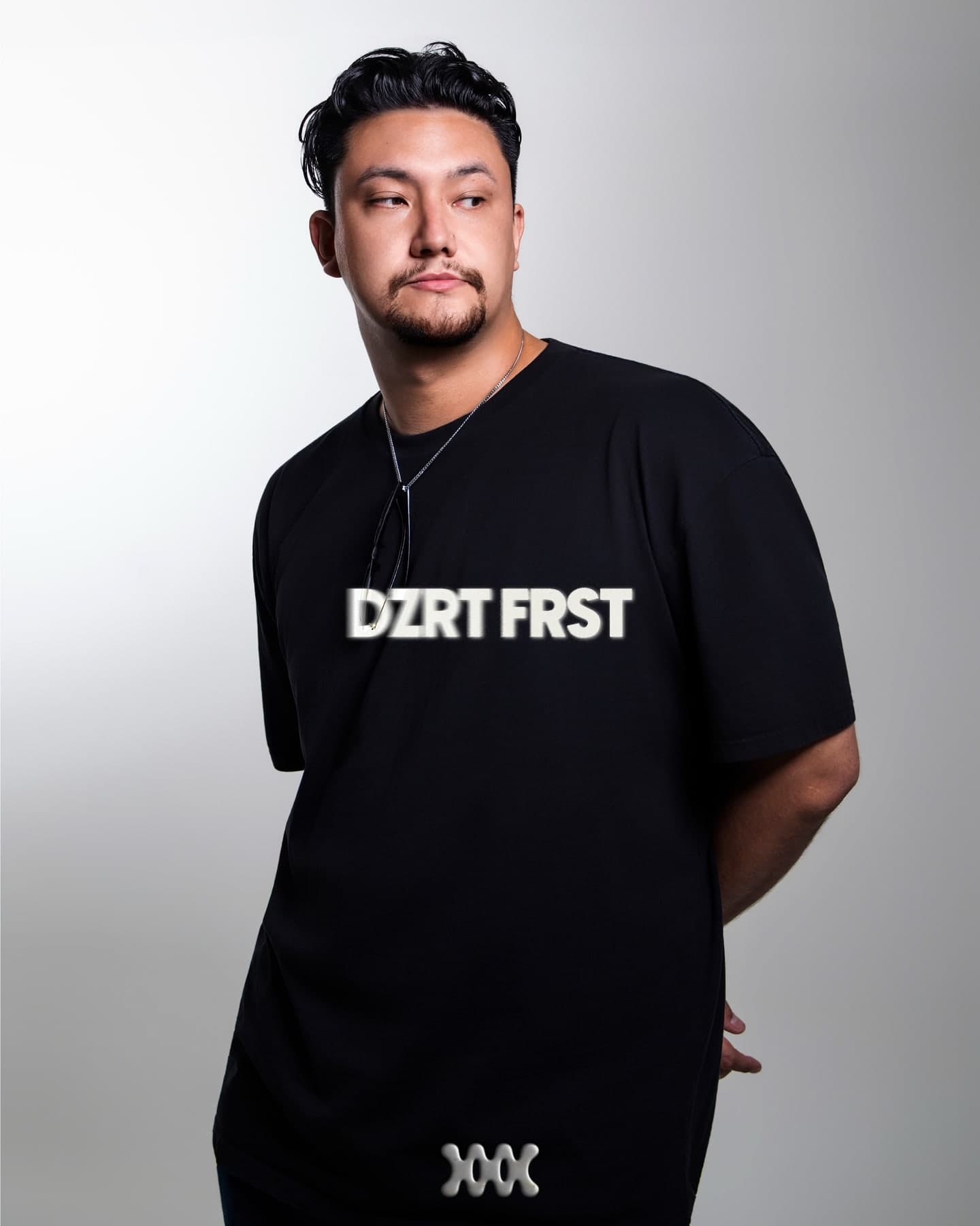 Studio portrait of DZRT FRST on grey, name over the chest